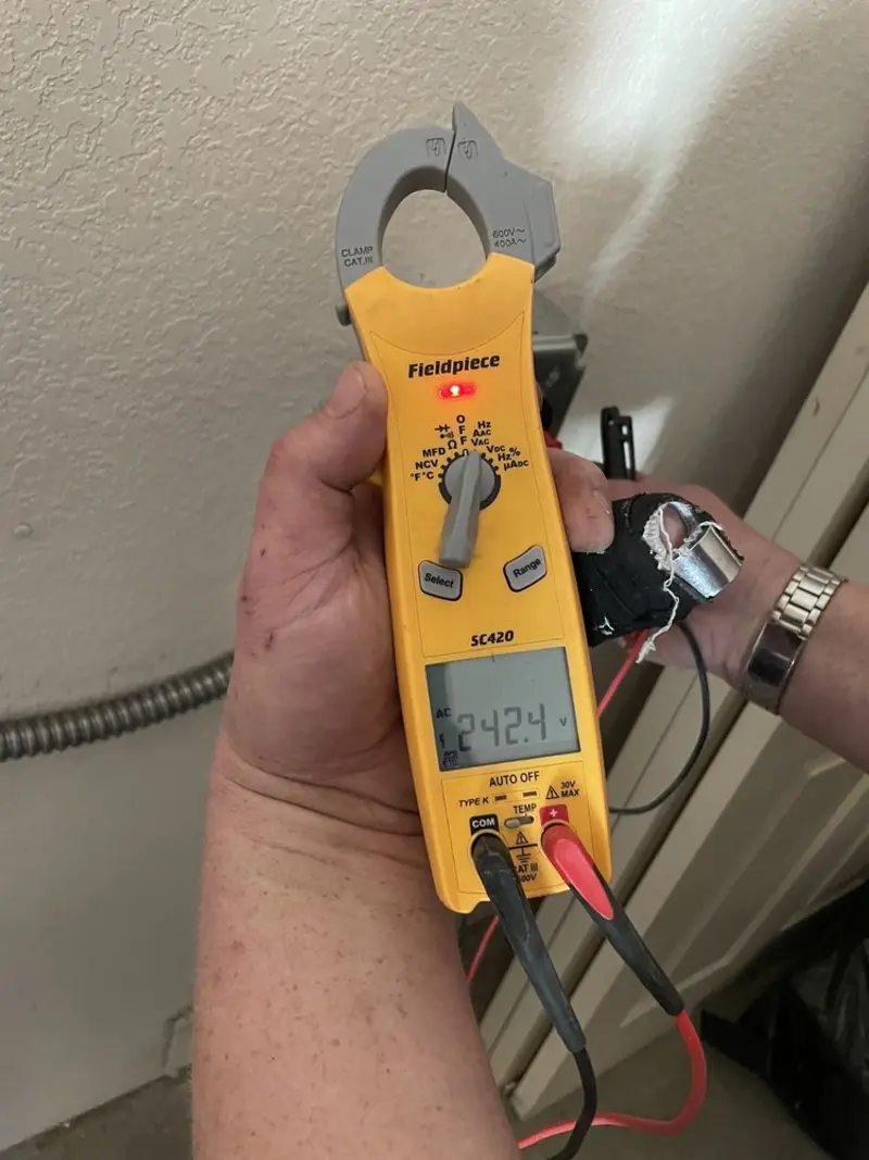 Voltage testing with clamp meter during Recessed Lighting Installation in Mills River